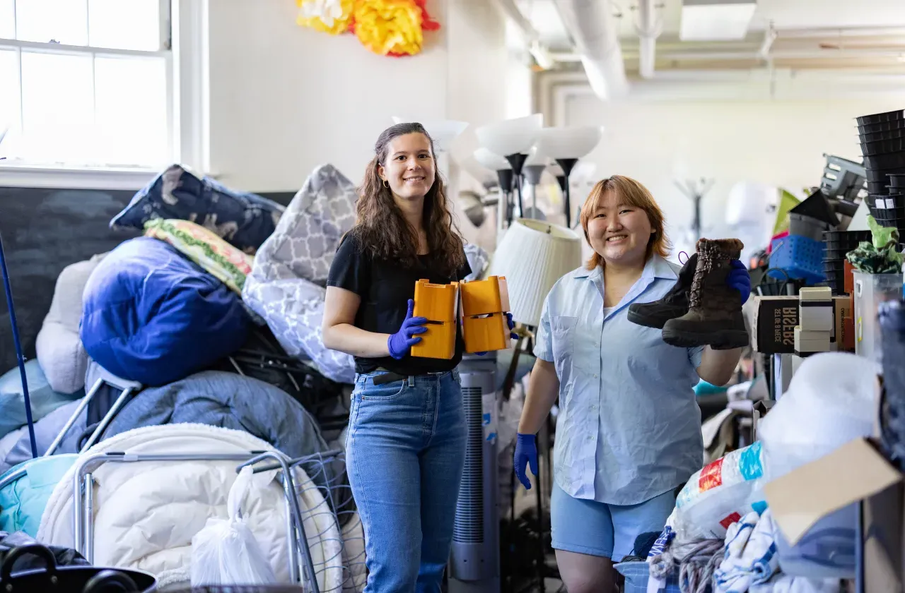 Jena Kim and Molly Neu sorting through items at SmithCycle in Scales House basement